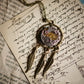 Necklace with a clockwork and feather design on an old letter background