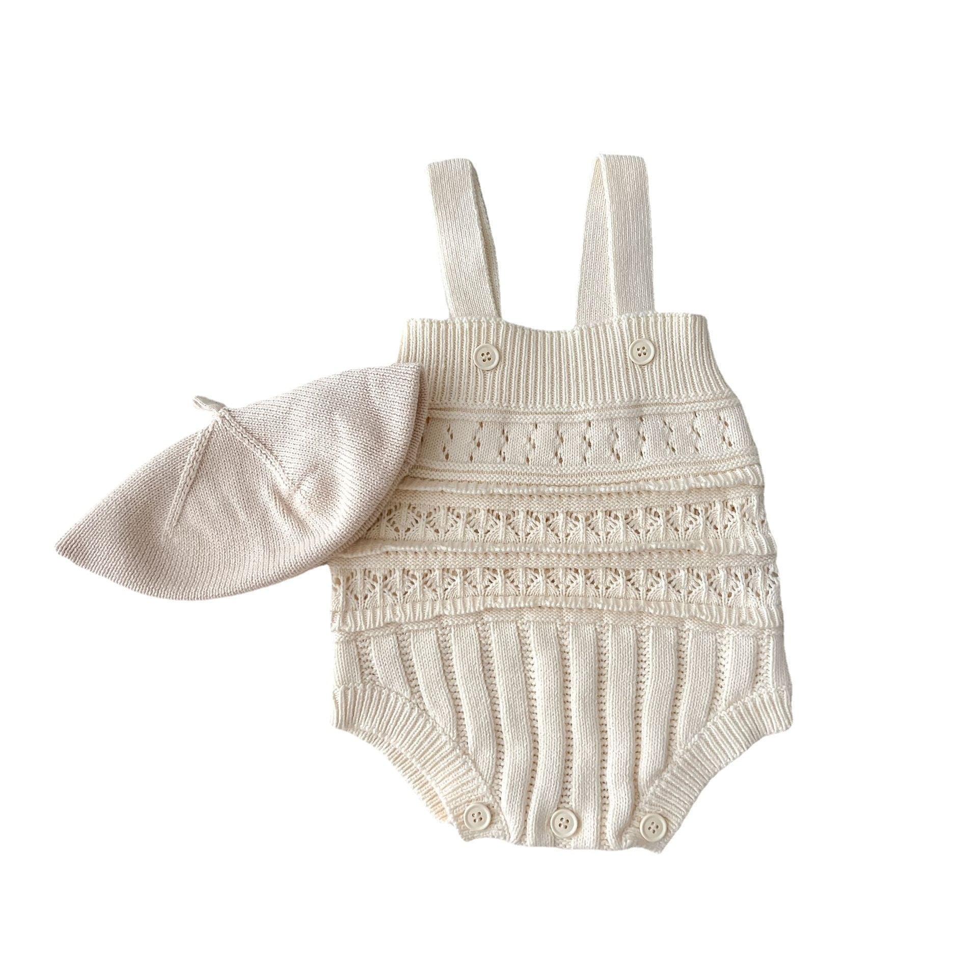 Baby romper with lace details and matching hat on a white background