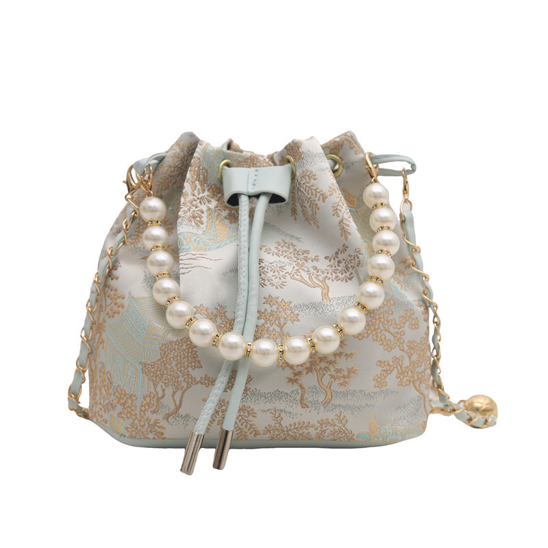 Small bag with pearl detailing on a white background