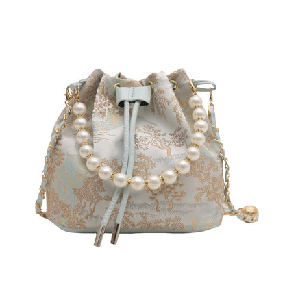 Small bag with pearl detailing on a white background