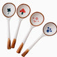 Set of four ceramic spoons with wooden handles and colorful designs on the bowls.