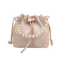 Pink drawstring bag with pearl details on a white background