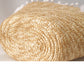Rolled-up straw mat on a light background