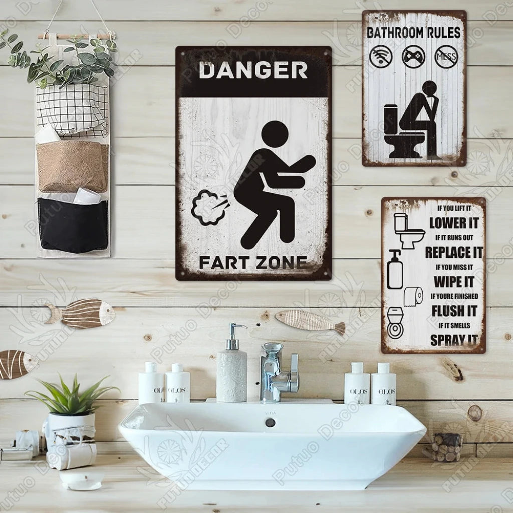 Bathroom with humorous 'Fart Zone' sign and various wall decorations.