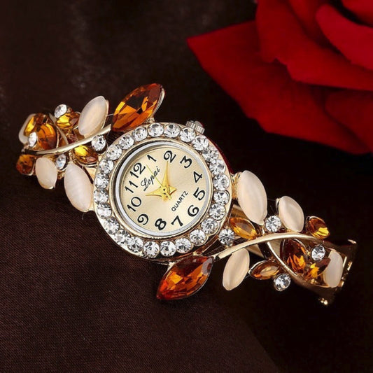 Decorative wristwatch with gemstone accents on a dark background