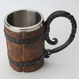 Wooden mug with metal handle and rim on a white background