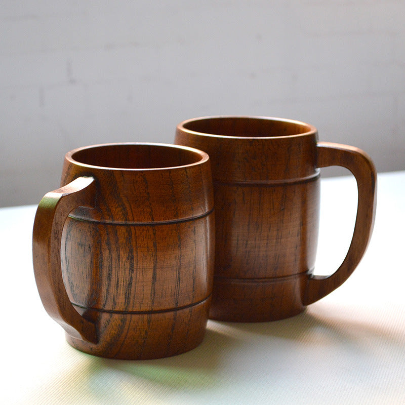 Two wooden mugs on a light surface with a neutral background
